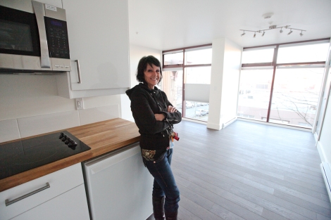 Atira's intergeneration mentorship program coordinator Jennifer Kleinsteuber inside a soon-to-be-occupied suite. Misgivings about housing women in 'crates' evaporated amid 'amazement at how beautiful these looked on the outside and on the inside,' she says. Photo by David P. Ball